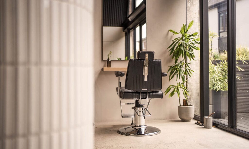 Styling chair beside large windows at mosu hair space