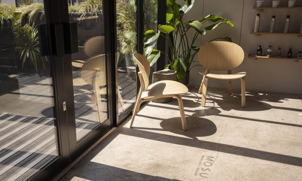 Waiting area with lounge chairs inside mosu hair space